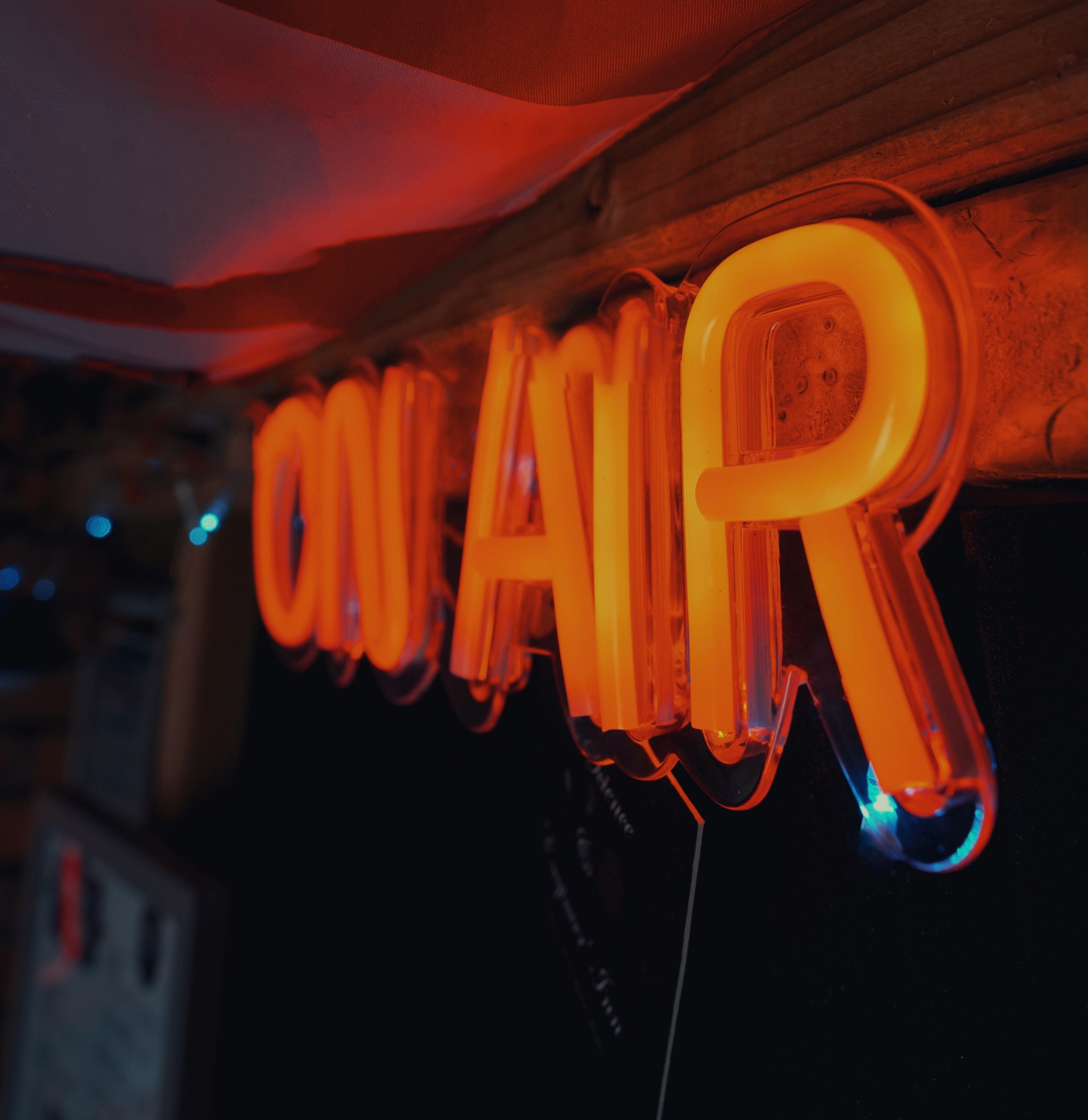 Illuminated orange neon On Air sign in a radio studio