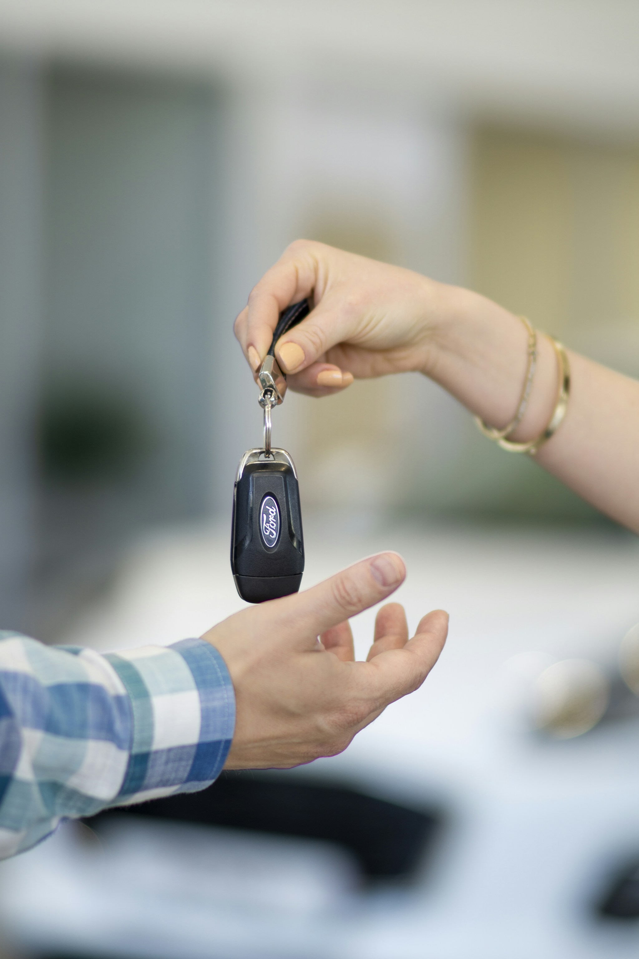 Car key being handed over to a buyer