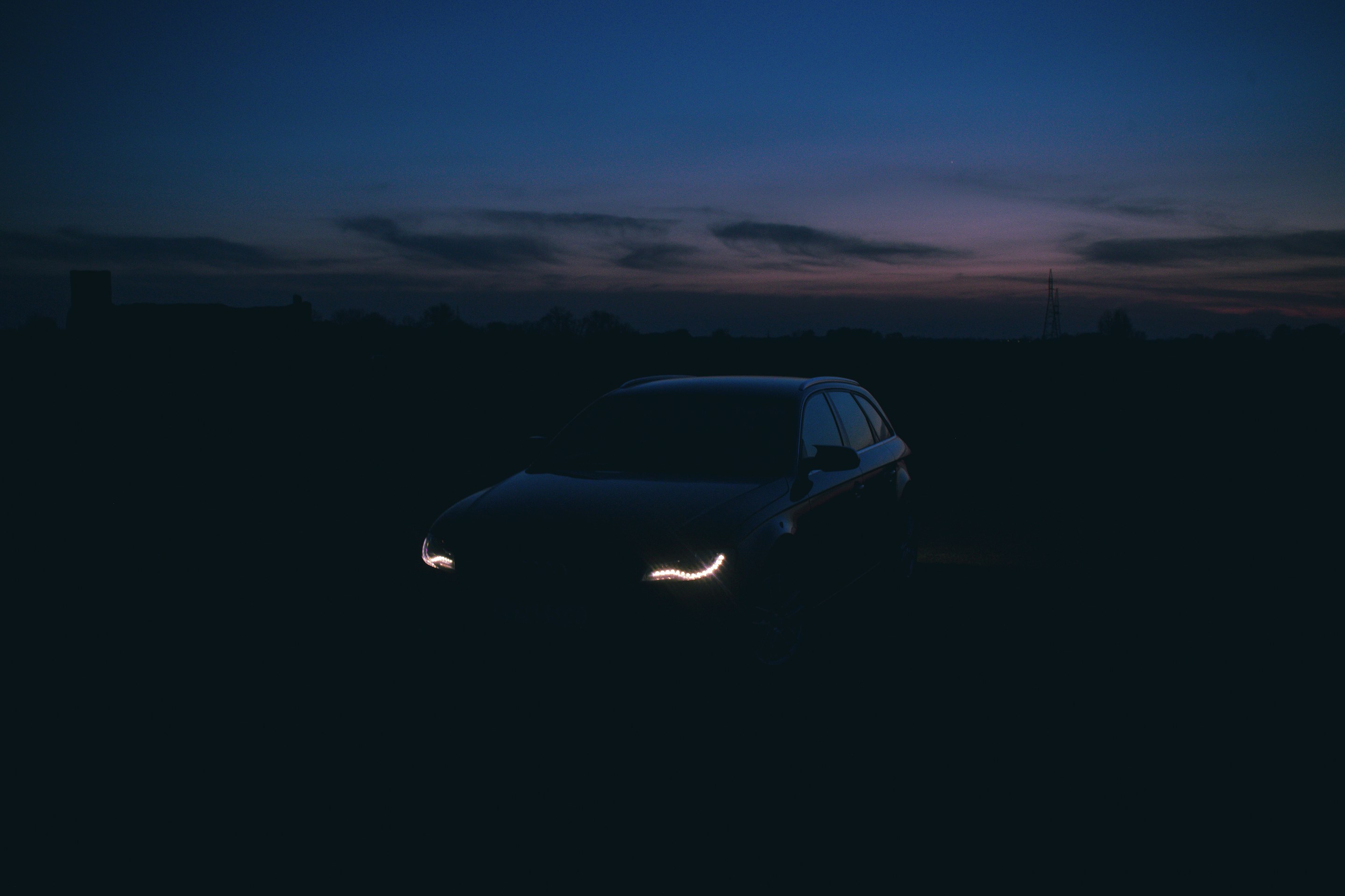 Car with its headlights on at dusk
