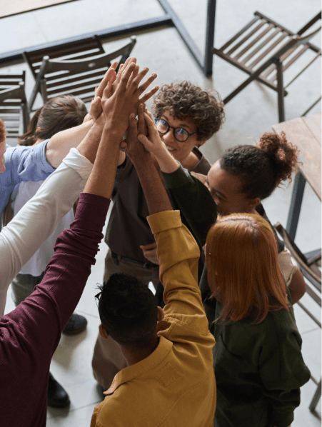 Group of young people joining hands in a high five