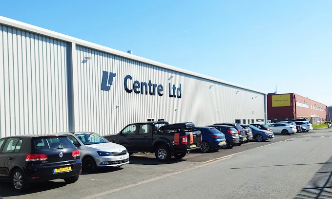 LR Centre warehouse with vehicles parked outside