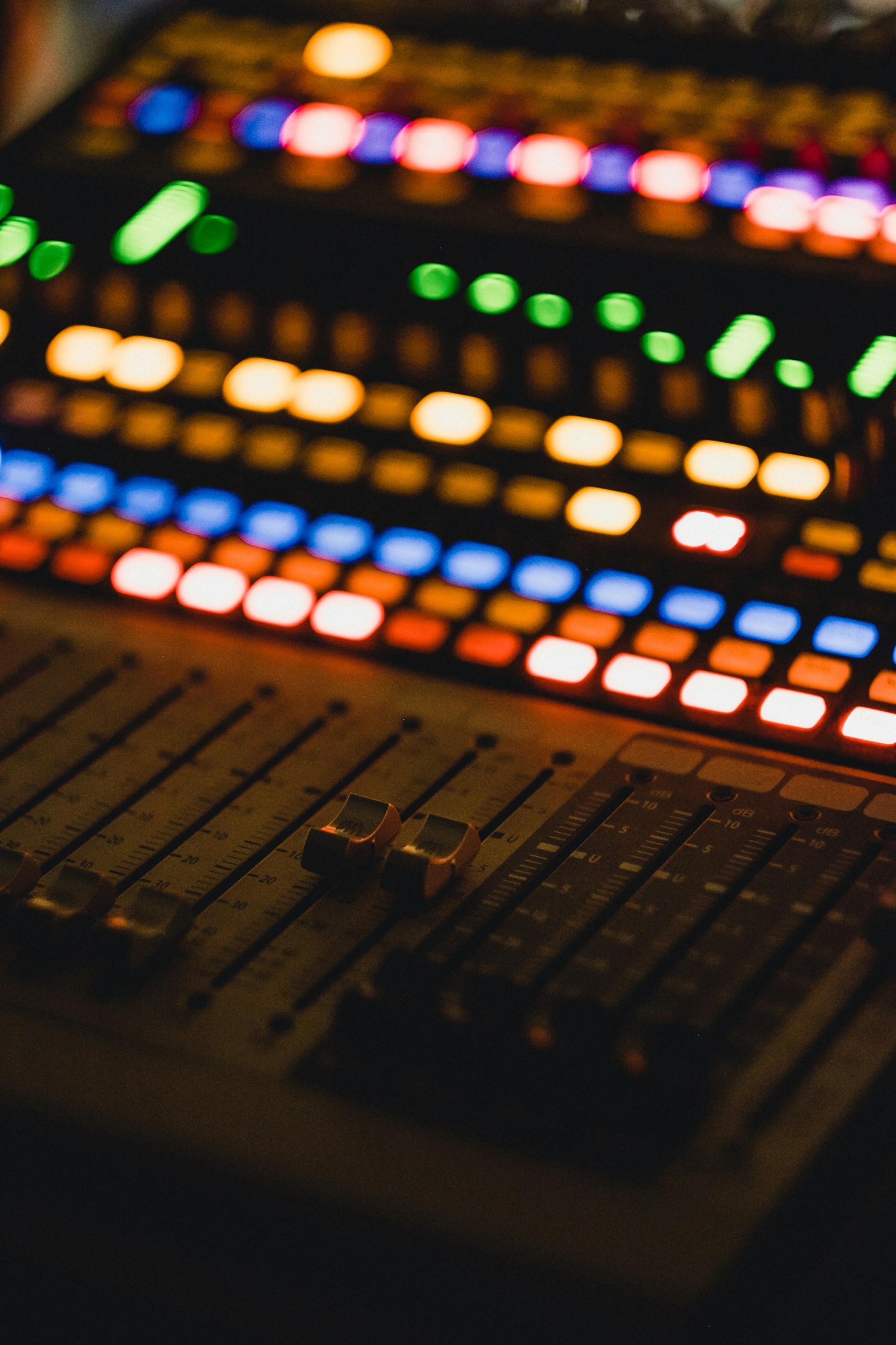Close-up of illuminated buttons on a sound mixing desk