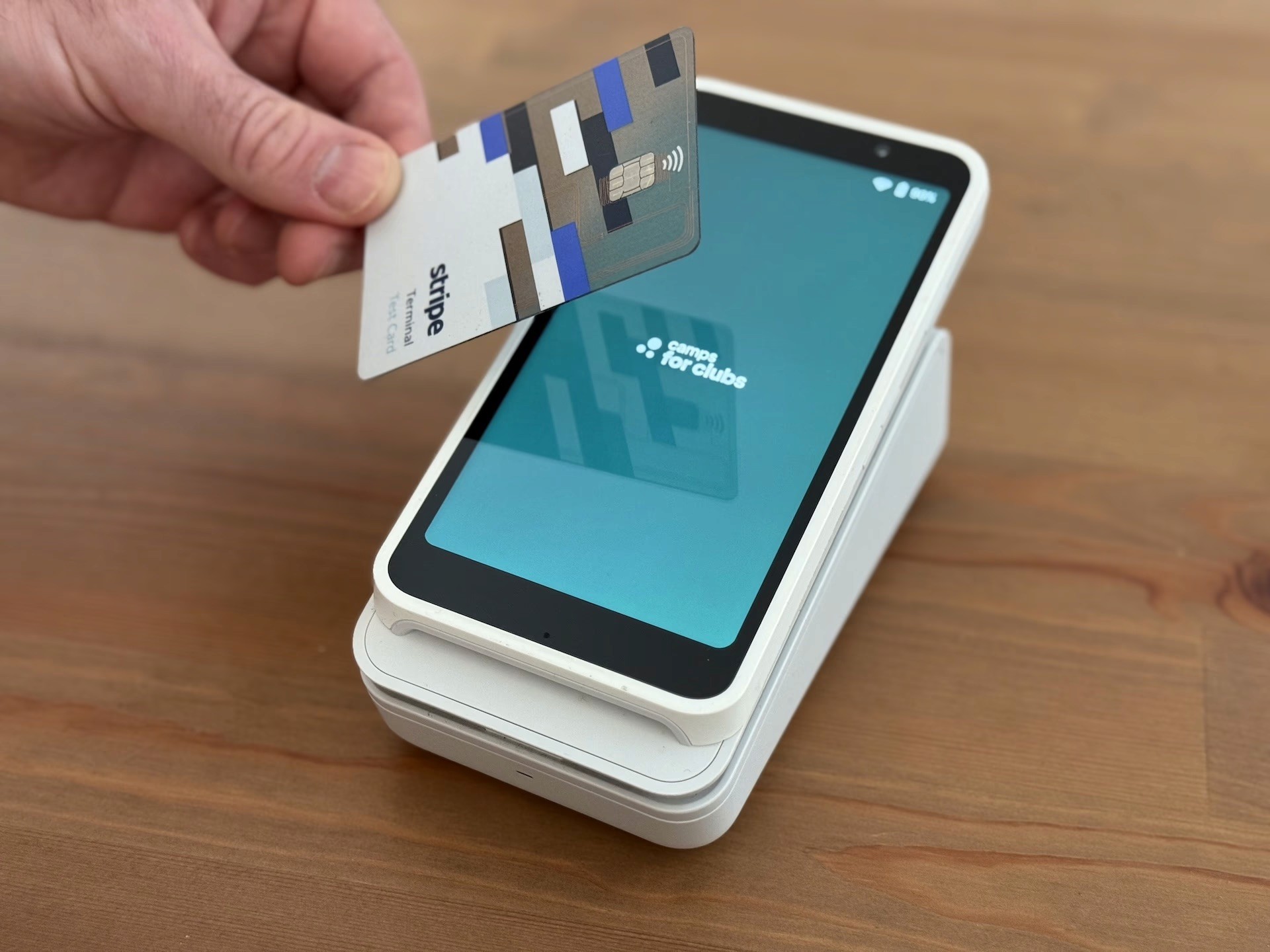 A customer tapping a payment card on a terminal