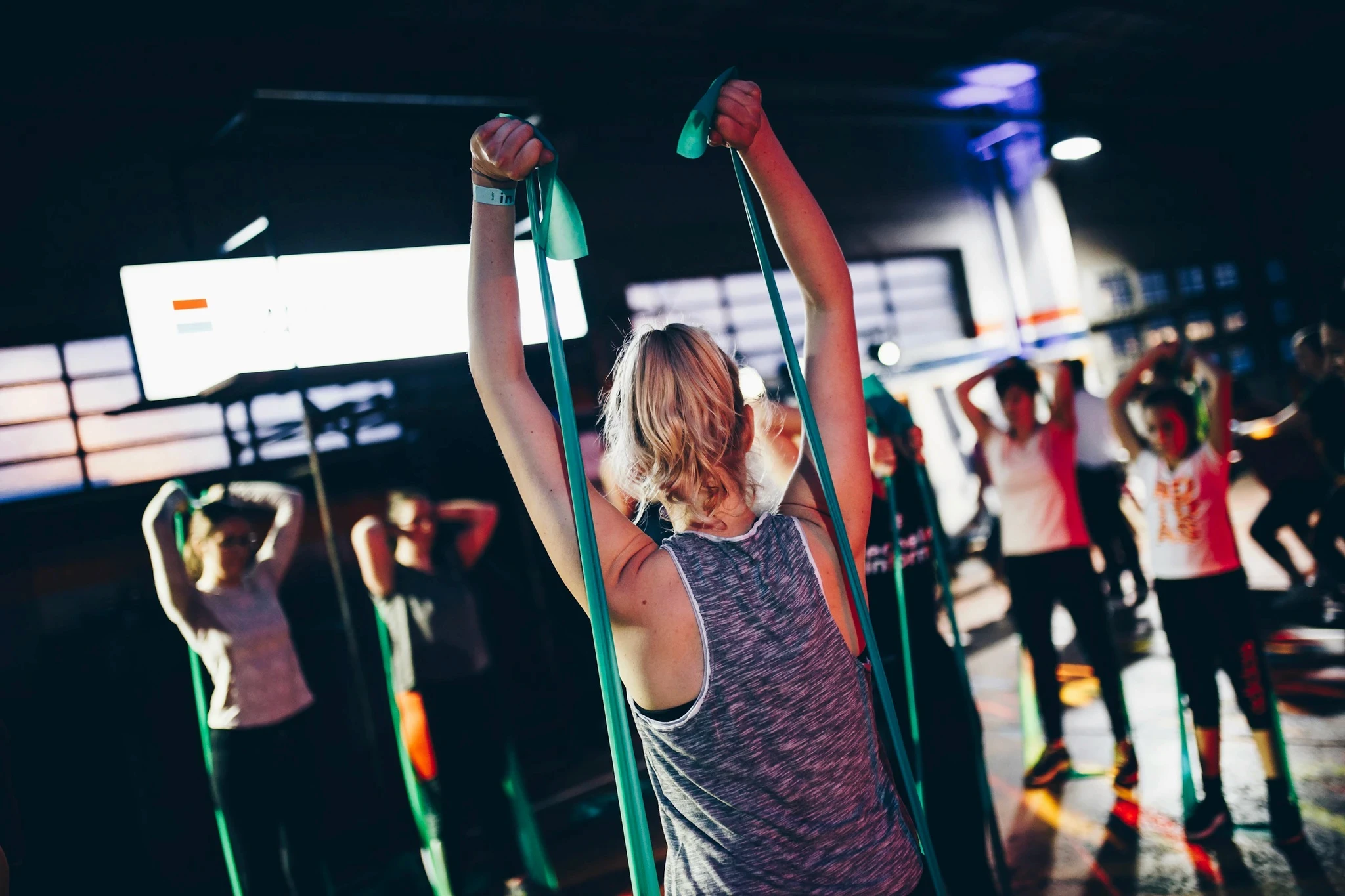 Group fitness class exercising with resistance bands